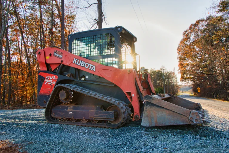 Compact track loader parked on a gravel road