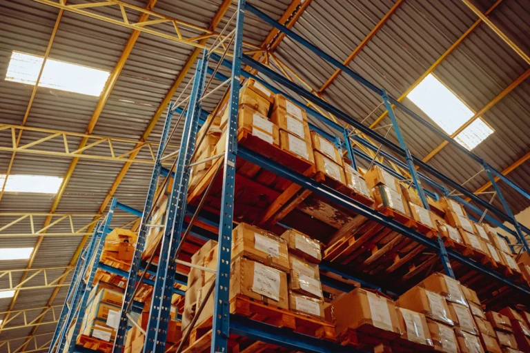 Boxed freight stacked on pallets in warehouse racking